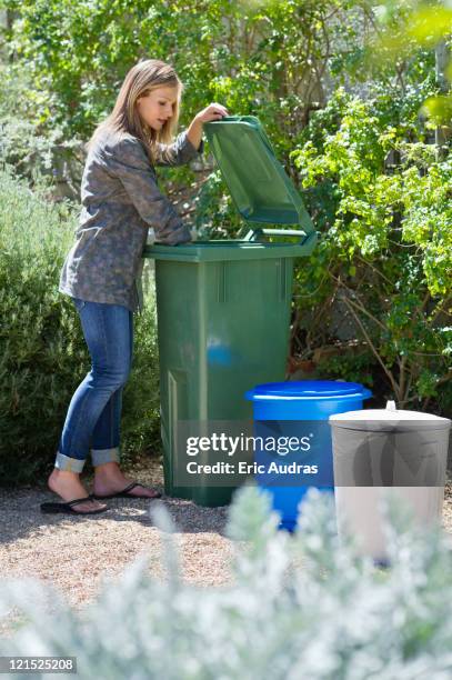 woman looking into recycling bin - garbage bin lid open stock pictures, royalty-free photos & images