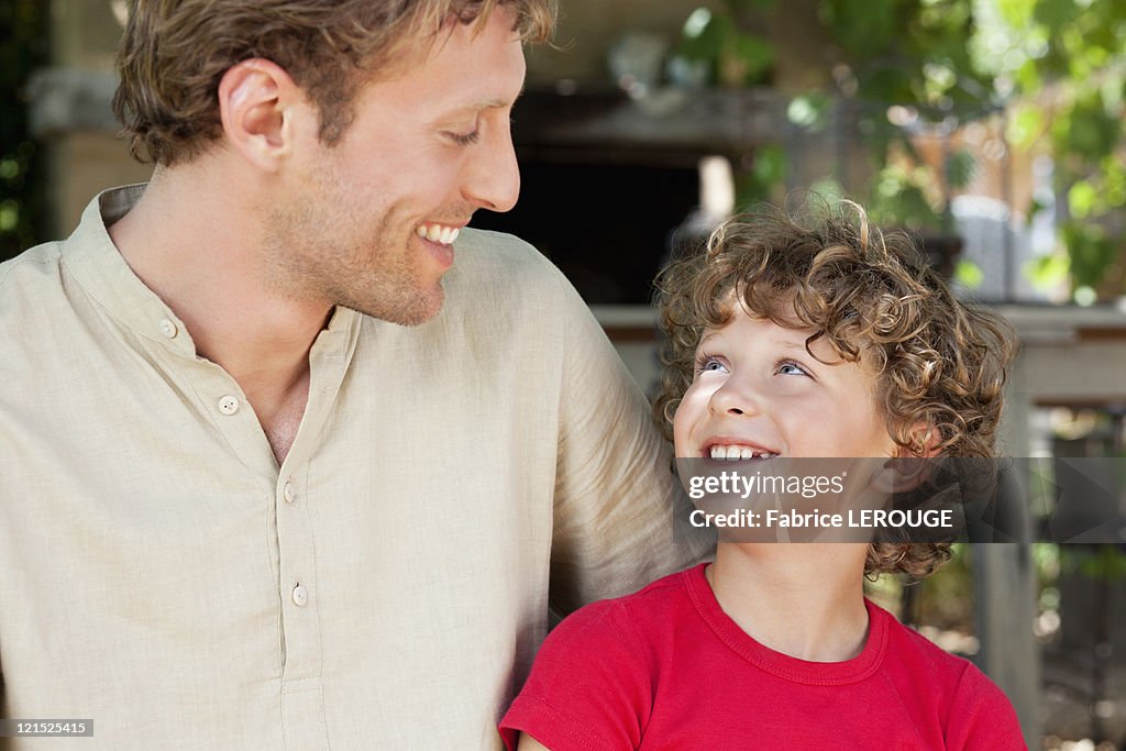 Happy father and son looking at each other