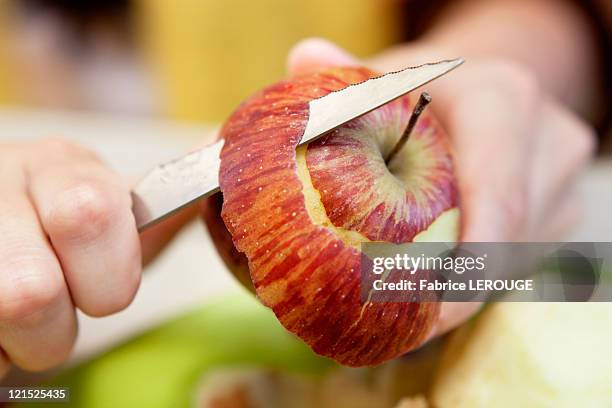 close-up of man's hand peeling an apple - geschält stock-fotos und bilder