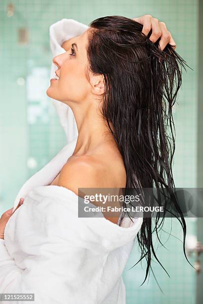 woman wearing bathrobe after taking a bath - wet hair fotografías e imágenes de stock