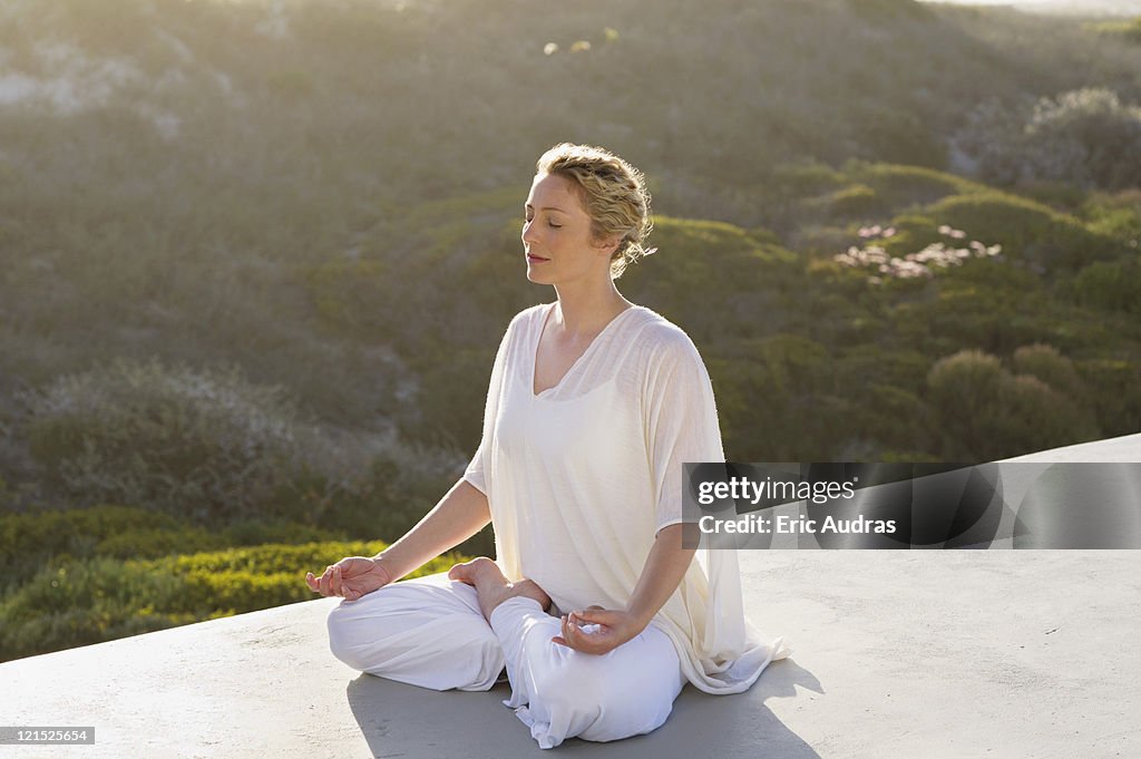 Mid adult woman meditating