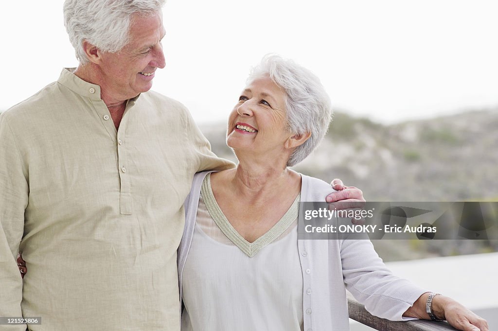 Senior man standing with his arm around a senior woman