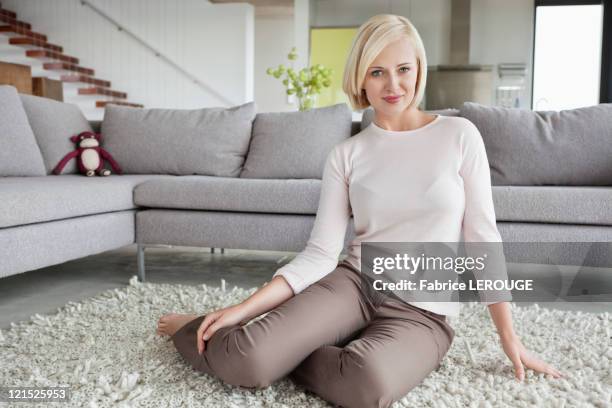 portrait of a woman sitting on carpet - sitting on ground stock pictures, royalty-free photos & images