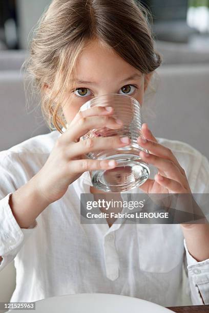 portrait of a girl drinking water - girl drinking water stock pictures, royalty-free photos & images