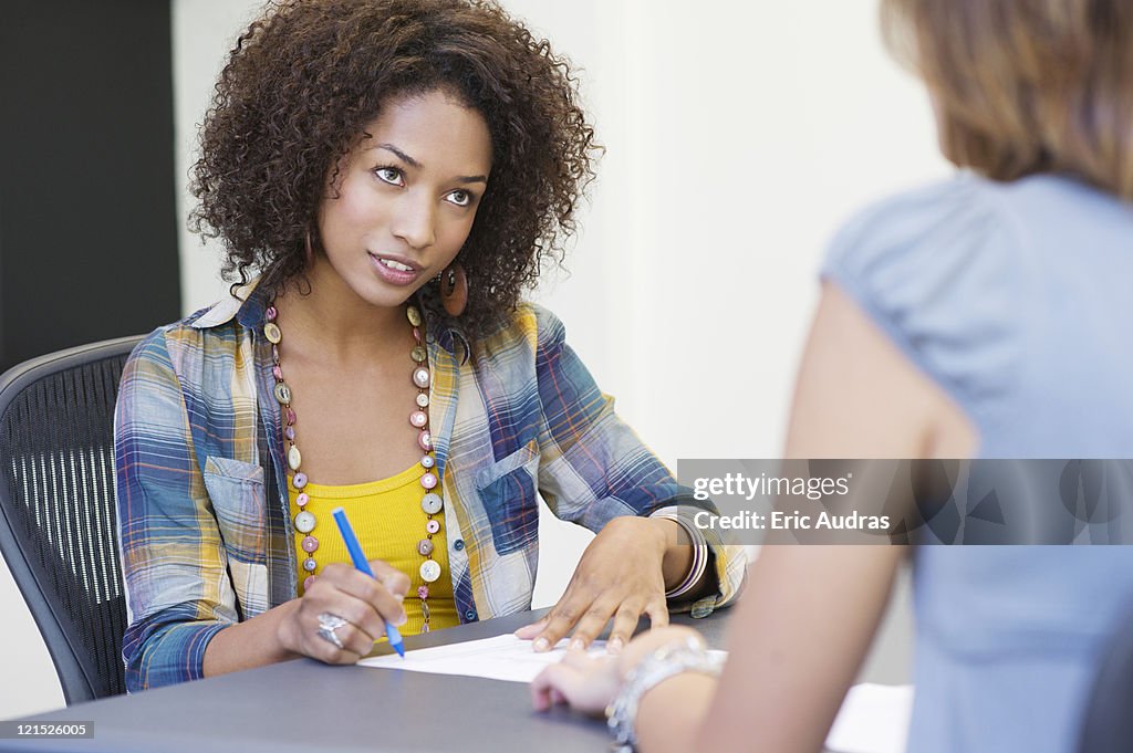 African American woman taking an interview of a woman