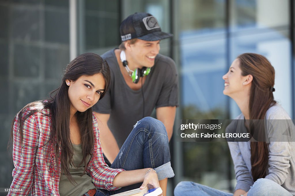Friends Looking Portrait Of A Woman Sitting With Her Friends Looking At Each Other High ...