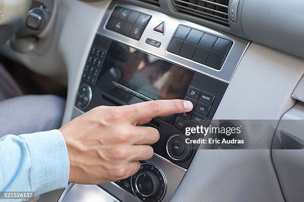 man playing the music in car - auto radio stockfoto's en -beelden