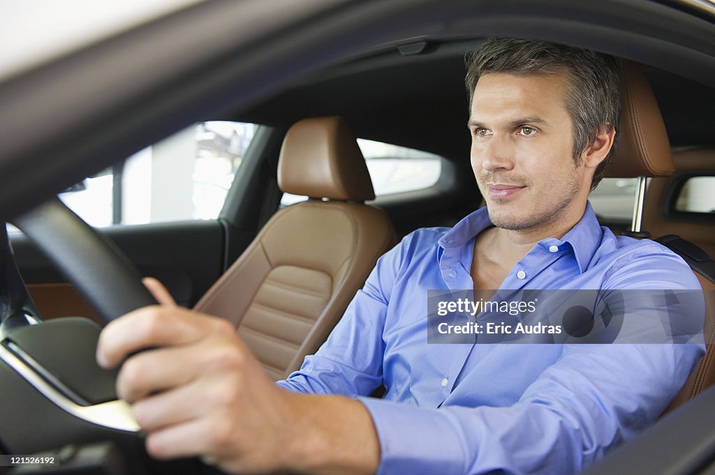 Mid adult man taking a test drive