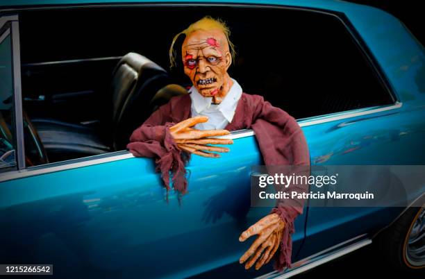 zombie in a blue classic car - halloween mannequin stock pictures, royalty-free photos & images