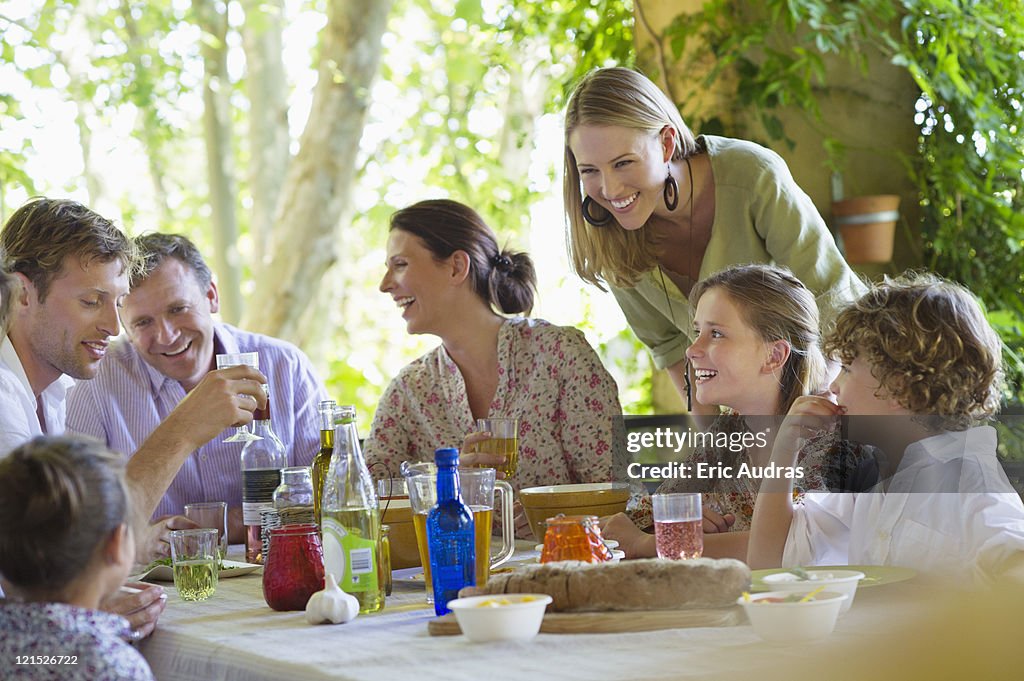 Multi generation family eating food at house