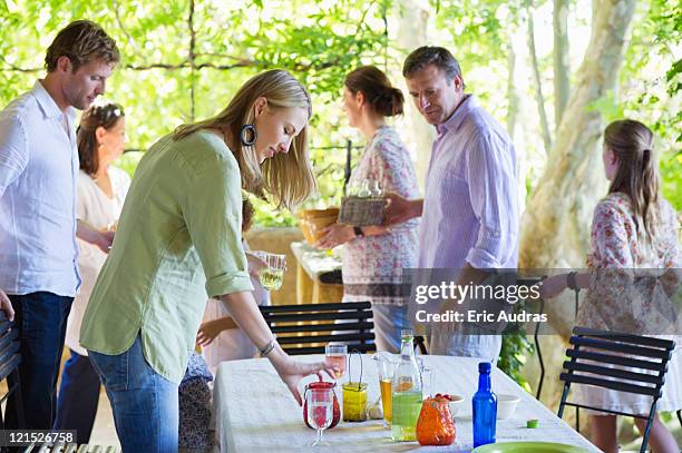 family cleaning table after having food at house - cleaning after party stock pictures, royalty-free photos & images