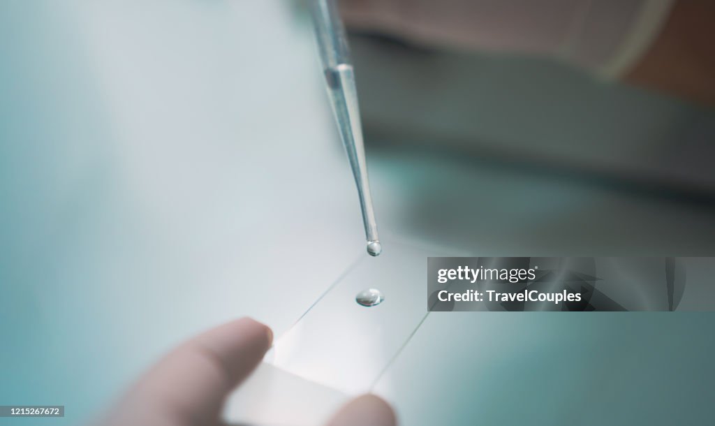 Science and medicine. Scientist analyzing and dropping a sample into a glassware. Experiments containing chemical liquid in laboratory on glassware. DNA structure. Innovative and technology.