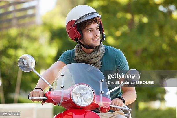 man riding a scooter - man with scooter stock pictures, royalty-free photos & images