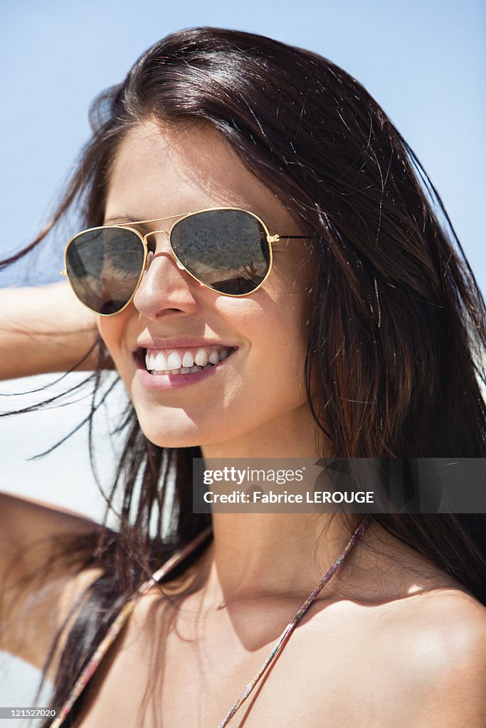 Close-up of a young woman wearing sunglasses