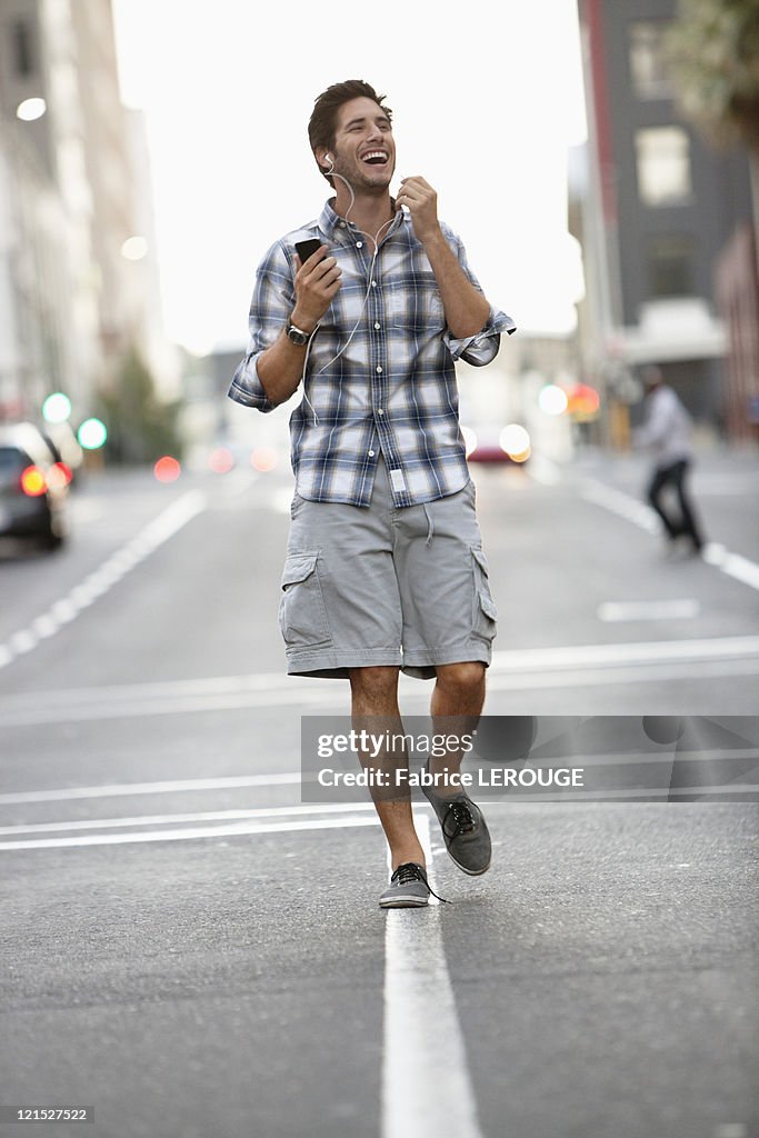 Man talking on a mobile phone while walking on the road