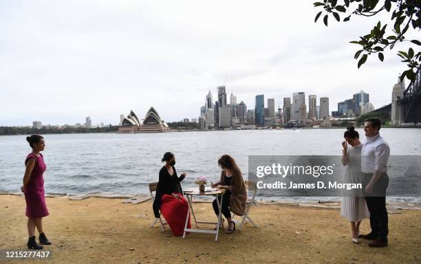 Lara Laas and Daniel Clark watch their two witnesses sign the marriage paperwork as they are married at Captain Henry Waterhouse Reserve in...