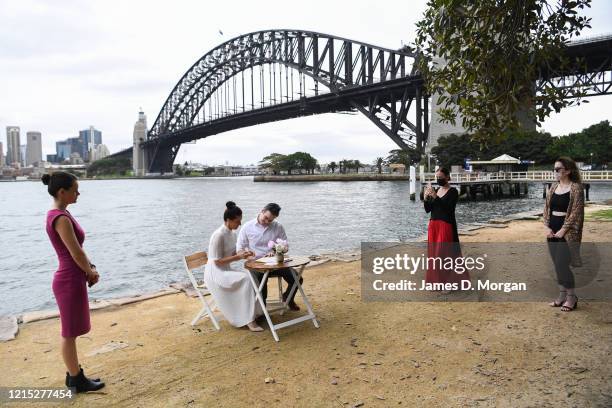 Lara Laas and Daniel Clark as they are married at Captain Henry Waterhouse Reserve in Kirribilli on March 28, 2020 in Sydney, Australia. Weddings are...
