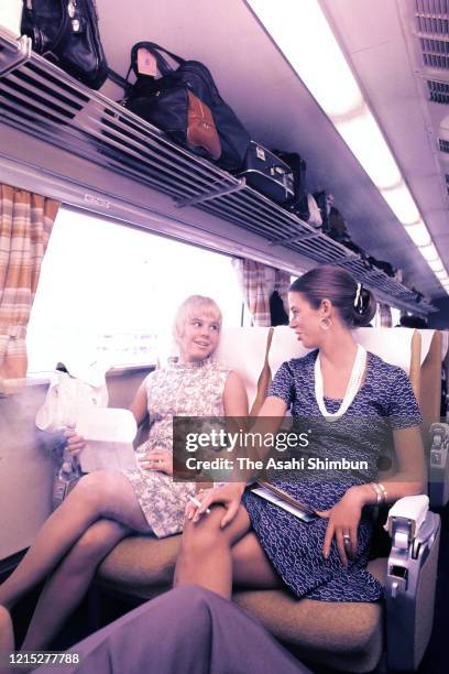 Figure skater Janet Lynn talks with her friend on the Shinkansen on June 25, 1972 in Tokyo, Japan.