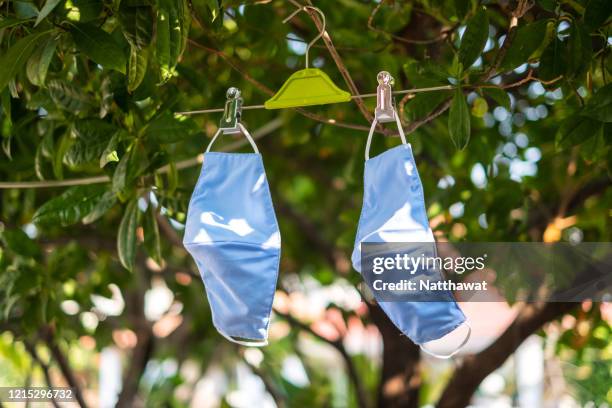 hanging and drying fabric face masks in the sun - cloth face mask stock pictures, royalty-free photos & images