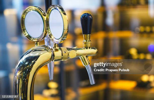 the beer taps in a pub. - bier zapfhahn stock-fotos und bilder