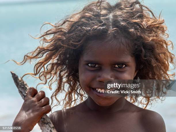portrait of a young indigenous girl with curly hair - aboriginal girl stock pictures, royalty-free photos & images