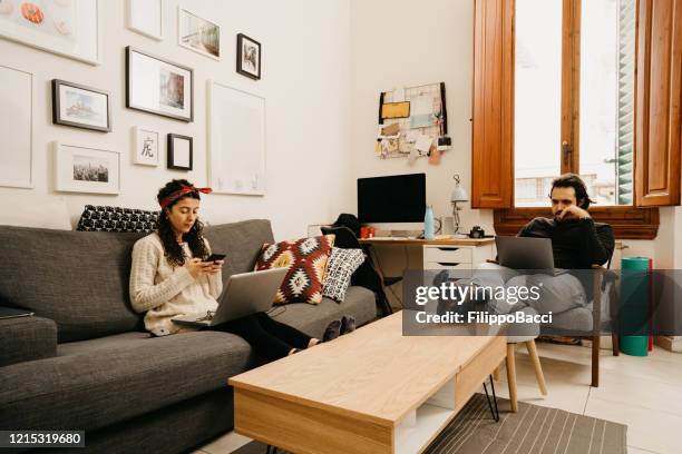 young couple working from home - togetherness covid stock pictures, royalty-free photos & images