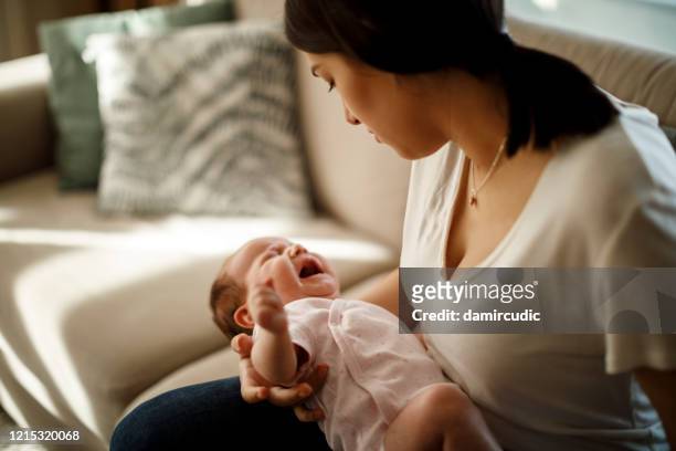 newborn baby crying in mother hands - screaming stock pictures, royalty-free photos & images