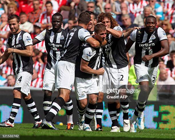 Newcastle United's English defender Ryan Taylor celebrates his goal with team-mates during the English Premier League football match between...