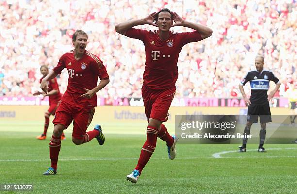 Daniel van Buyten and Holger Badstuber of Bayern Muenchen celebrate van Buyten's first goal during the Bundesliga match between FC Bayern Muenchen...