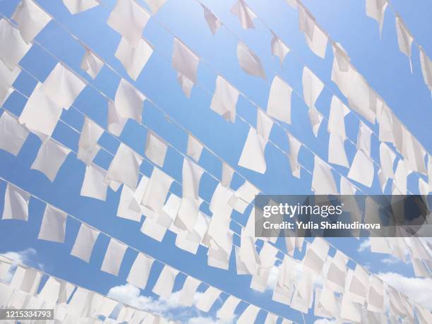 white fabric bunting banner rectangle flags garland decoration background wallpaper - festival float stock pictures, royalty-free photos & images