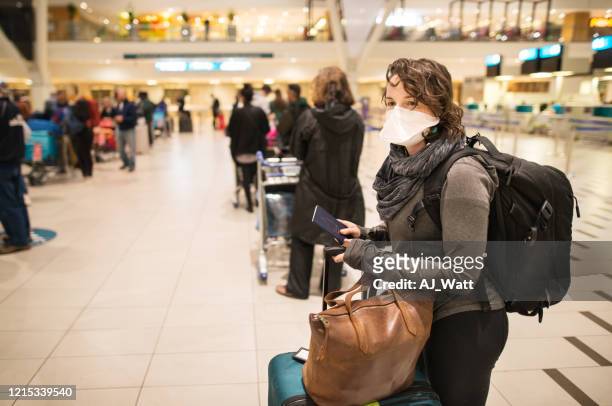 at the airport with a face mask - coronavirus travel stock pictures, royalty-free photos & images
