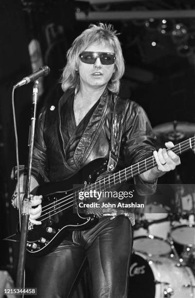 Bassist Benjamin Orr is shown performing on stage during a live concert appearance with The Cars on November 19, 1987.