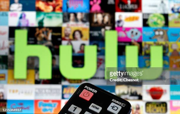 In this photo illustration, a remote control is seen in front of a television screen showing a Hulu logo on March 28, 2020 in Paris, France. As the...