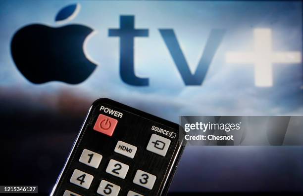 In this photo illustration, a remote control is seen in front of a television screen showing an Apple TV + logo on March 28, 2020 in Paris, France.