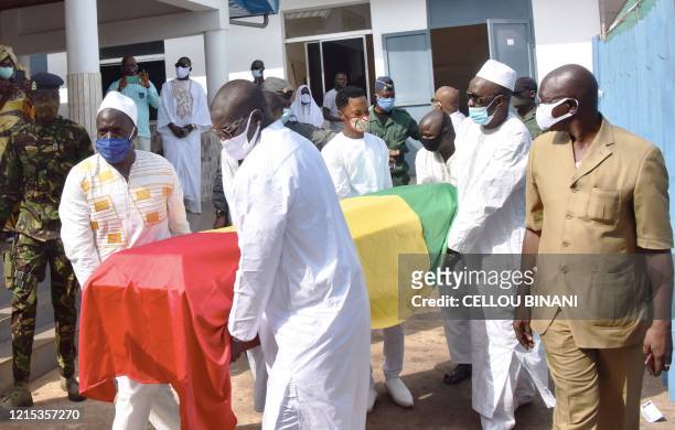 Mourners carry the coffin of the late Guinean singer Mory Kante during his funeral procession on May 26, 2020 in Conakry Guinea. Hundreds of people...