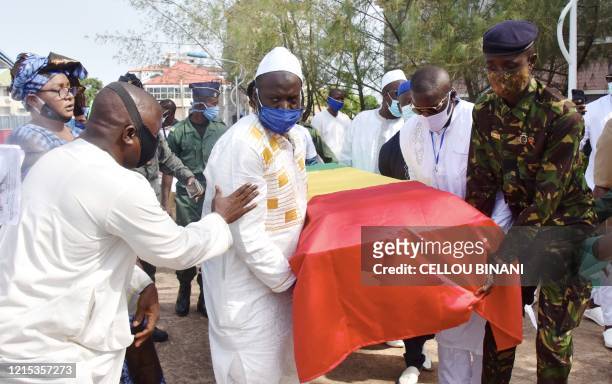 Mourners carry the coffin of the late Guinean singer Mory Kante during his funeral procession on May 26, 2020 in Conakry Guinea. Hundreds of people...