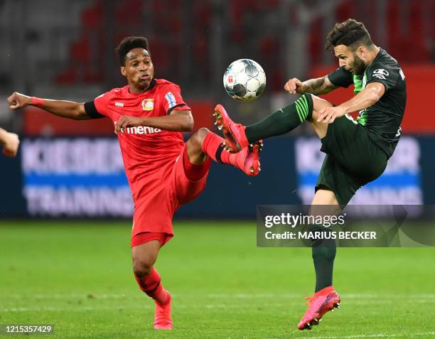 Leverkusen's Brazilian defender Wendell (L0 and Wolfsburg's Swiss midfielder Renato Steffen vie for the ball during the German first division...