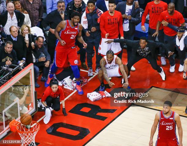 Philadelphia 76ers center Joel Embiid and Toronto Raptors forward Kawhi Leonard watch as the ball bounces around the rim. Toronto Raptors vs...