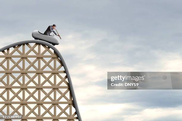 man on roller coaster looking through spyglass - high section stock pictures, royalty-free photos & images