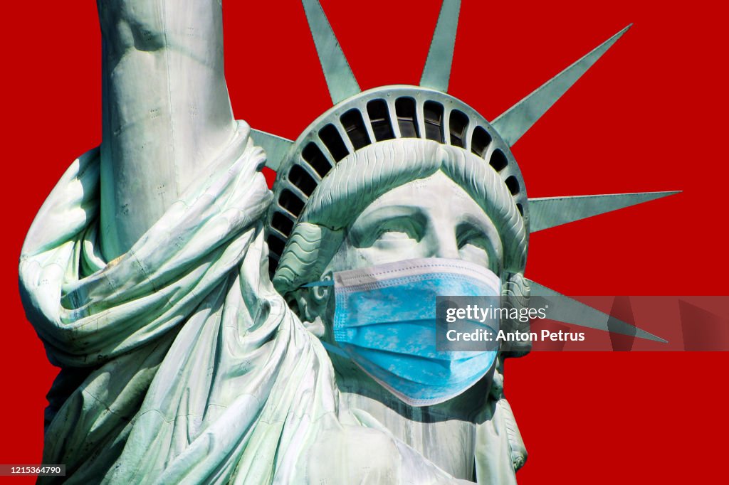 Coronavirus COVID-19 in USA. Statue of Liberty in a medical mask