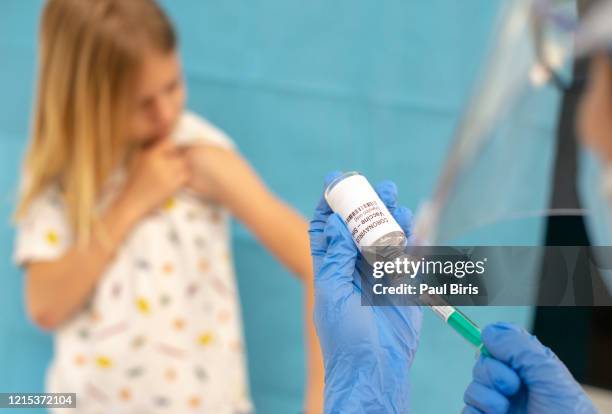 doctor injecting vaccination on child boy arm against covid-17, coronavirus desease. healthy and medical concept. - needle injury stock pictures, royalty-free photos & images