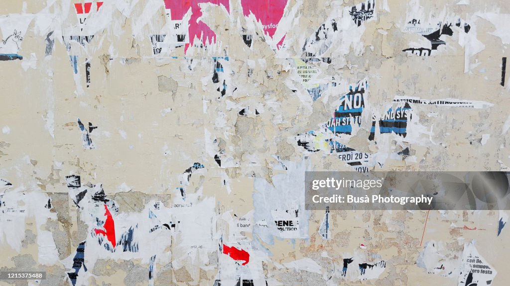Scratched posters on a wall