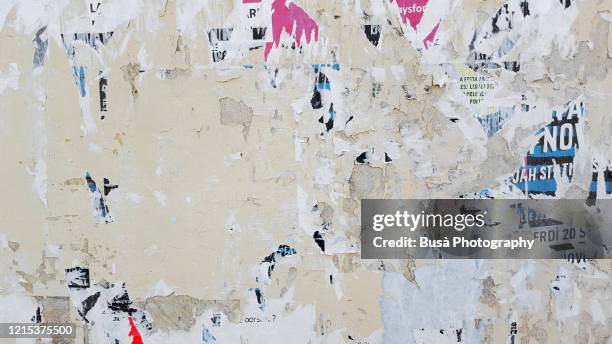 scratched posters on a wall - news background stock-fotos und bilder