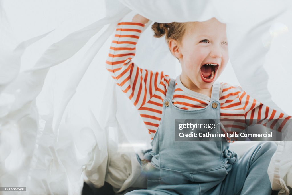 Playful Girl under a White Sheet
