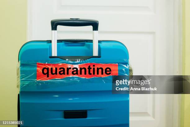 text quarantine over suitcase. concept of flights cancellation, travel restrictions due to coronavirus pandemic - quarantine stock pictures, royalty-free photos & images