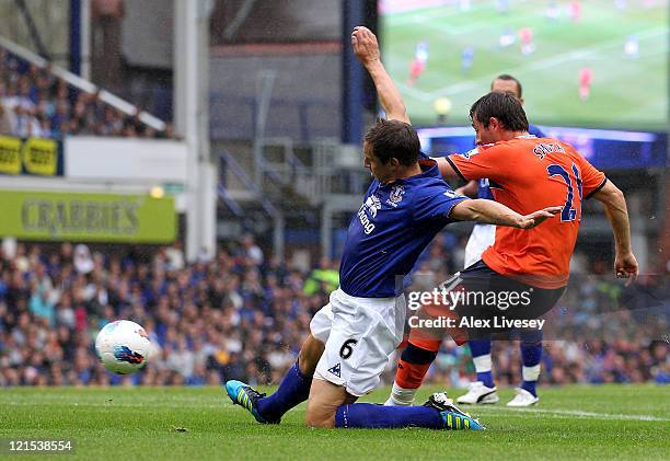 Tommy Smith of Queens Park Rangers scores the opening goal during the Barclays Premier League match between Everton and Queens Park Rangers at...