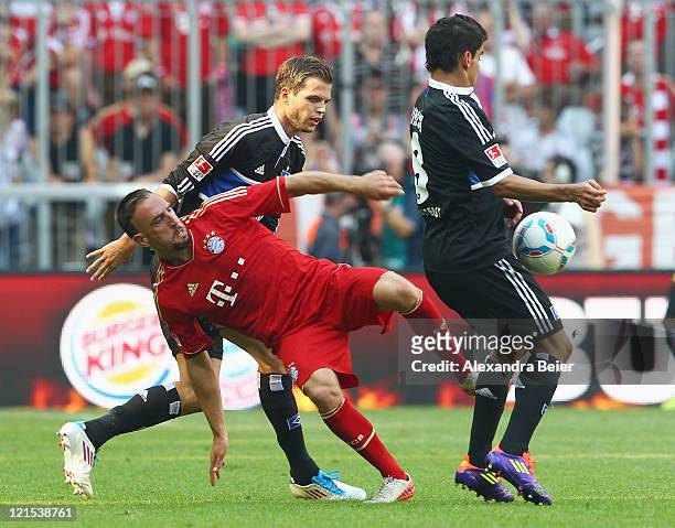 Franck Ribery of Bayern Muenchen fights for the ball with Dennis Diekmeier and Tomas Rincon of Hamburg during the Bundesliga match between FC Bayern...