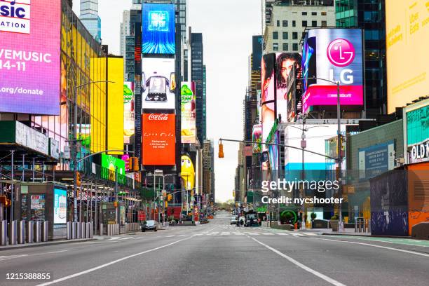 few visit times square ny during corona virus pandemic - times square manhattan stock pictures, royalty-free photos & images