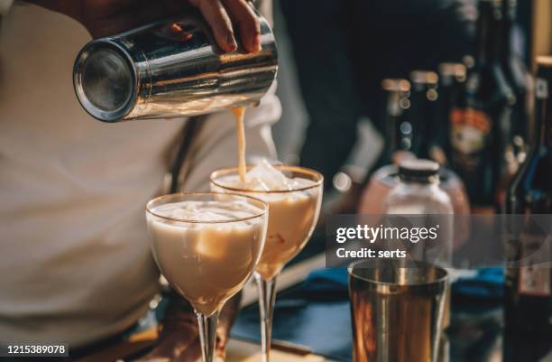 bartender preparing  irish cream liqueur cocktail with shaker - coffee and milk stock pictures, royalty-free photos & images