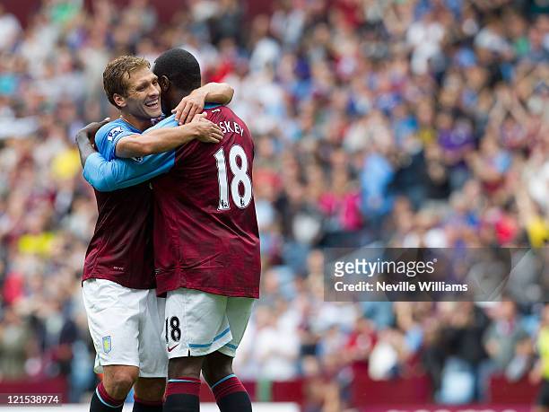Emile Heskey of Aston Villa celebrates his goal for Aston Villa with team mate Stilliyan Petrov during the Barclays Premier League match between...